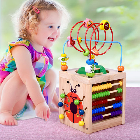 Image of Wooden children's puzzle beetle surrounded by large beads