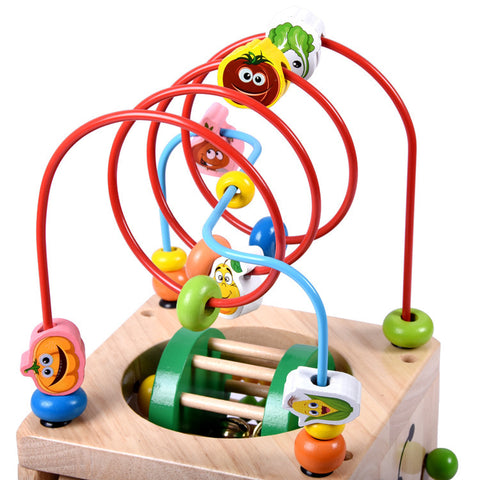 Image of Wooden children's puzzle beetle surrounded by large beads